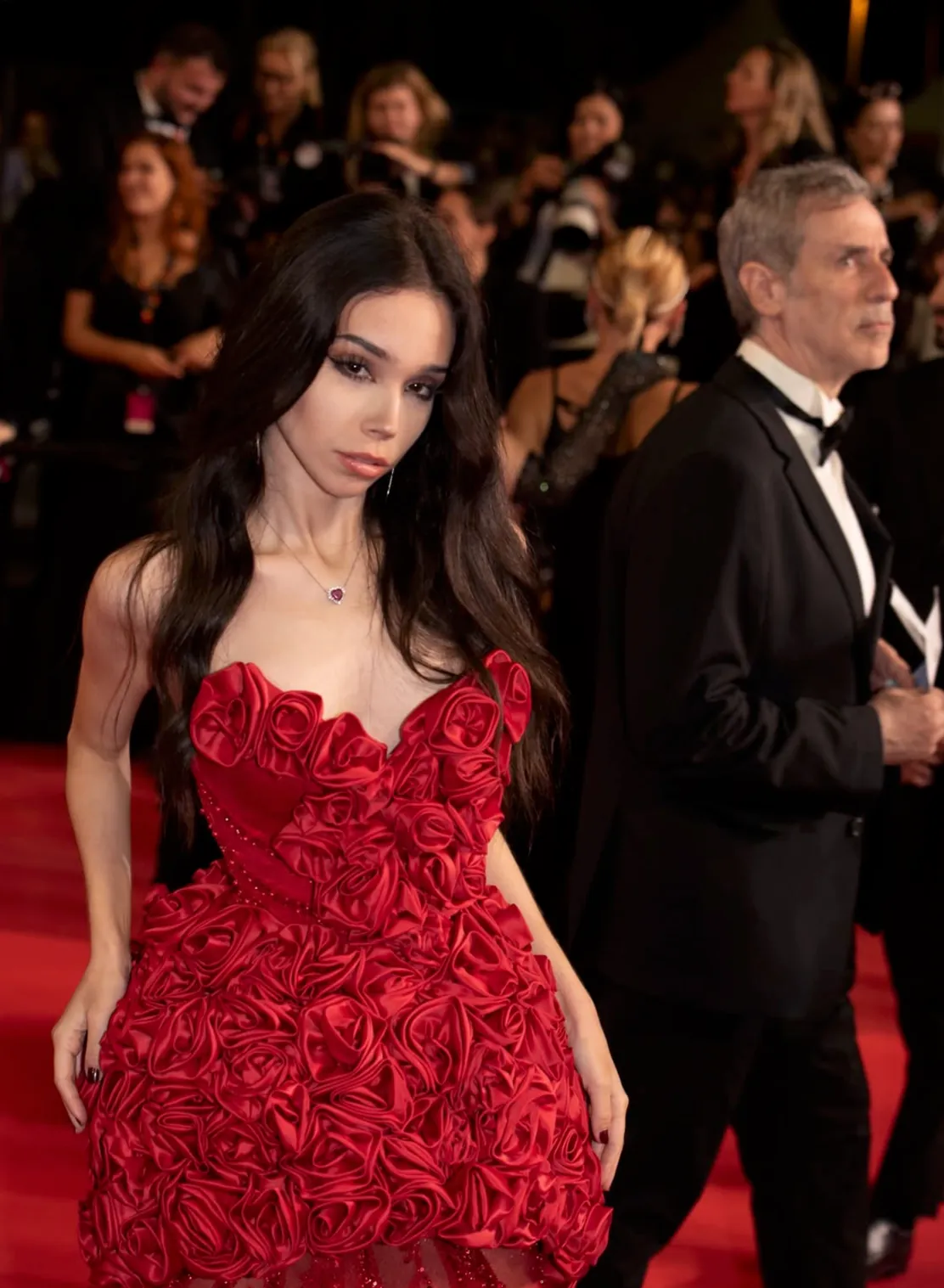 Cat Dantas on the red carpet in Cannes, in a gown of red roses